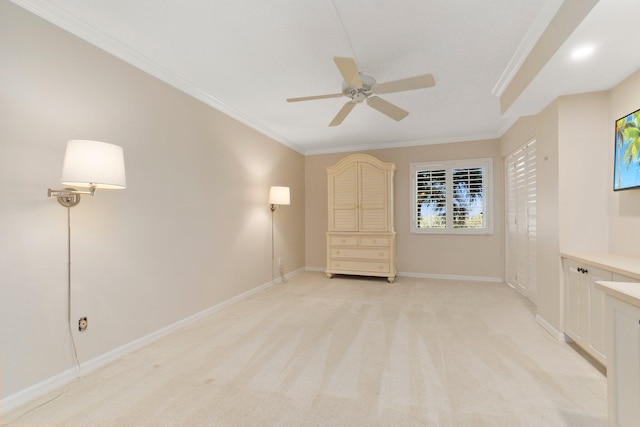 unfurnished bedroom featuring ceiling fan, crown molding, and light colored carpet