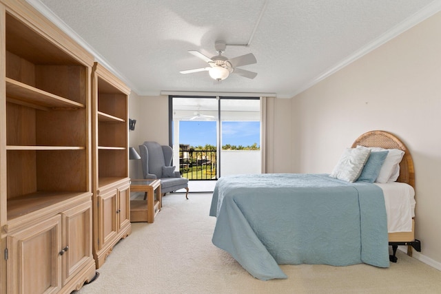 carpeted bedroom featuring ceiling fan, access to outside, a textured ceiling, and ornamental molding