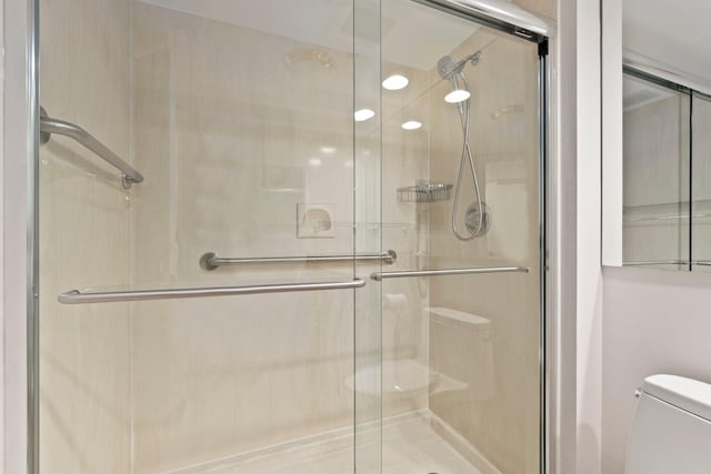 bathroom with walk in shower and toilet