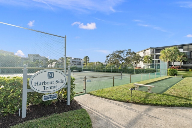 surrounding community with a lawn and tennis court