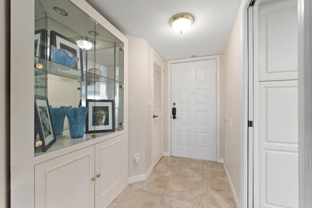 doorway to outside featuring light tile patterned flooring