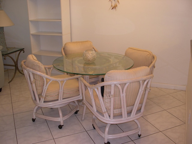 tiled dining space featuring built in shelves