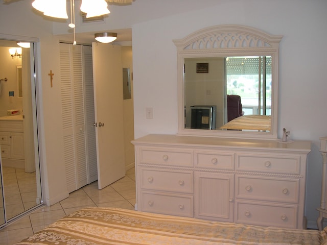 unfurnished bedroom with light tile patterned floors and ensuite bath