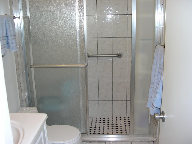 bathroom with vanity, toilet, and an enclosed shower