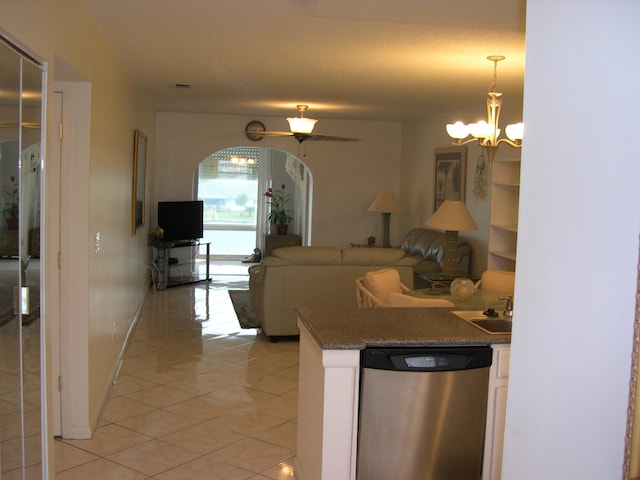 kitchen with ceiling fan with notable chandelier, decorative light fixtures, dishwasher, light tile patterned floors, and sink