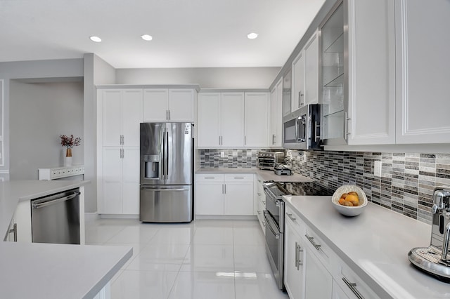 kitchen featuring backsplash, stainless steel appliances, and white cabinetry