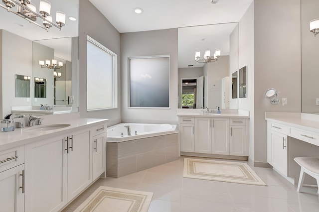 bathroom featuring tile patterned floors, vanity, and tiled tub