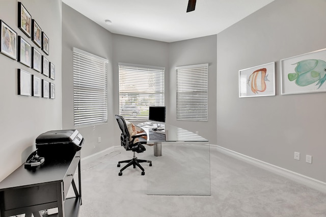 carpeted office featuring ceiling fan