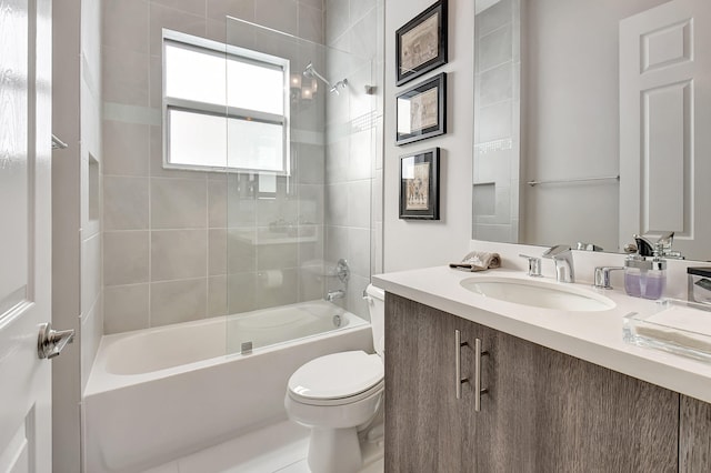 full bathroom featuring tile patterned flooring, vanity, toilet, and tiled shower / bath