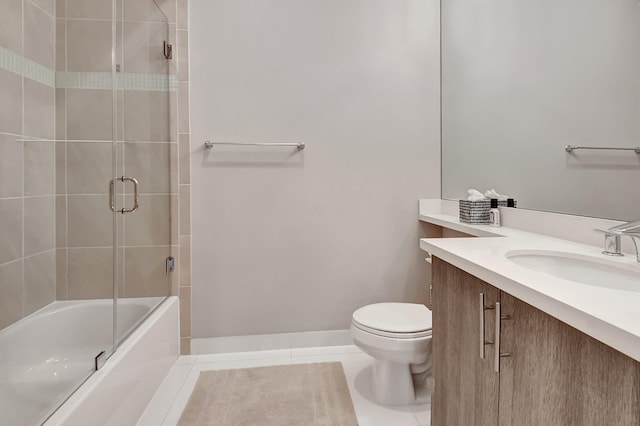 full bathroom with tile patterned flooring, vanity, toilet, and bath / shower combo with glass door