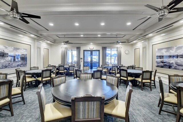 carpeted dining room featuring ceiling fan