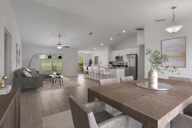 dining room featuring vaulted ceiling, ceiling fan, and sink