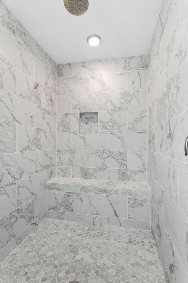 bathroom featuring tiled shower