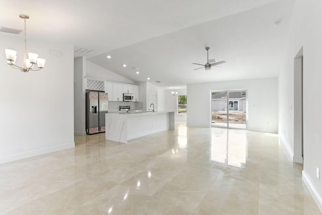 unfurnished living room featuring ceiling fan with notable chandelier, lofted ceiling, and sink