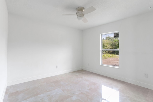 unfurnished room featuring ceiling fan and a textured ceiling