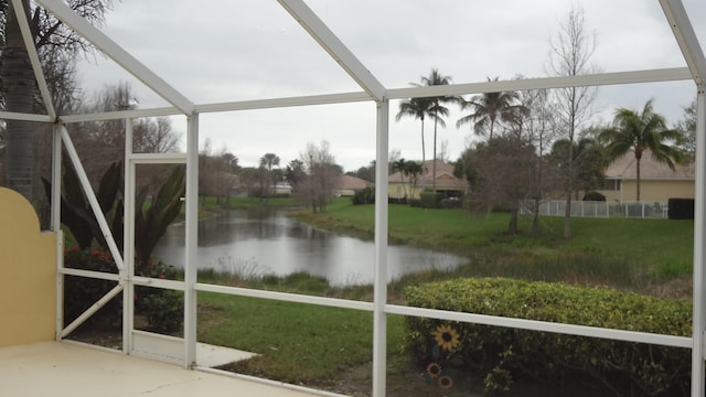 unfurnished sunroom with a water view