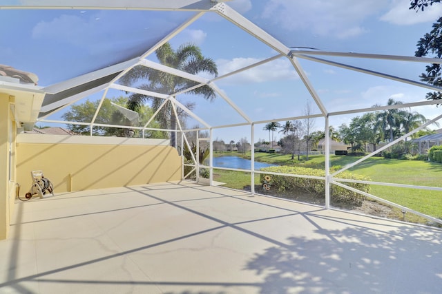 exterior space featuring a lanai and a water view