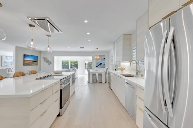 530 NW 14th St, Delray Beach, FL 33444 - kitchen featuring stainless steel appliances, modern cabinets, a sink, open floor plan, and recessed lighting