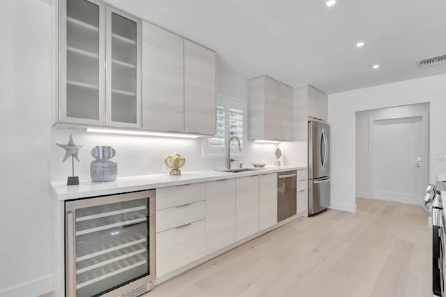 530 NW 14th St, Delray Beach, FL 33444 - kitchen featuring beverage cooler, appliances with stainless steel finishes, a sink, modern cabinets, and recessed lighting
