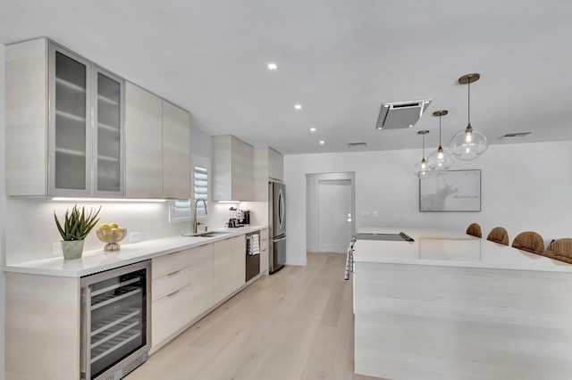 530 NW 14th St, Delray Beach, FL 33444 - kitchen featuring beverage cooler, modern cabinets, freestanding refrigerator, a sink, and recessed lighting