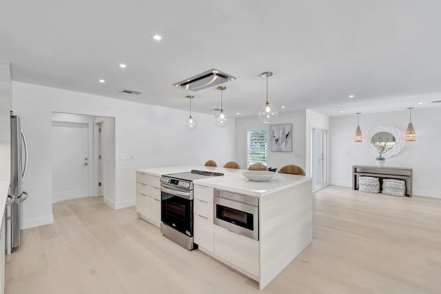 530 NW 14th St, Delray Beach, FL 33444 - kitchen with appliances with stainless steel finishes, modern cabinets, recessed lighting, light wood finished floors, and a kitchen island