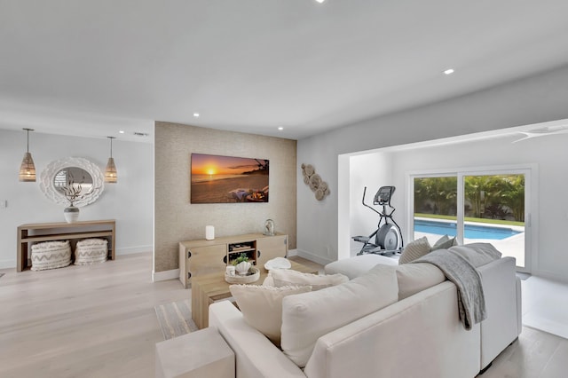 530 NW 14th St, Delray Beach, FL 33444 - living area with baseboards, an accent wall, light wood-style floors, and recessed lighting
