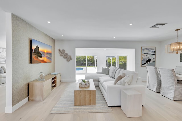 530 NW 14th St, Delray Beach, FL 33444 - living area featuring light wood-style flooring, baseboards, recessed lighting, a chandelier, and an accent wall