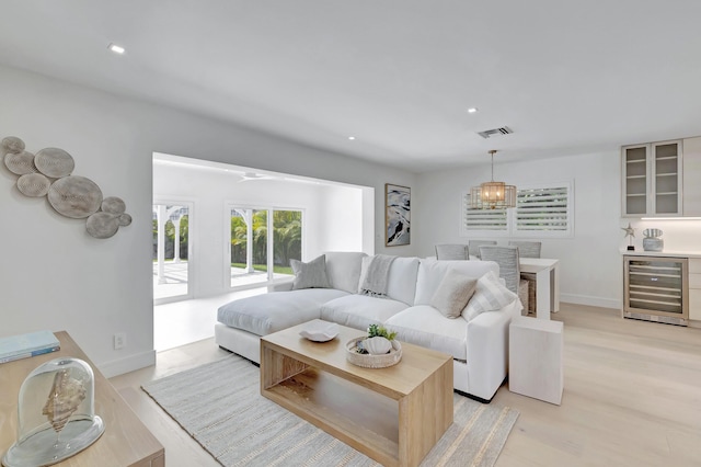 530 NW 14th St, Delray Beach, FL 33444 - living area with beverage cooler, light wood-type flooring, a chandelier, recessed lighting, and baseboards