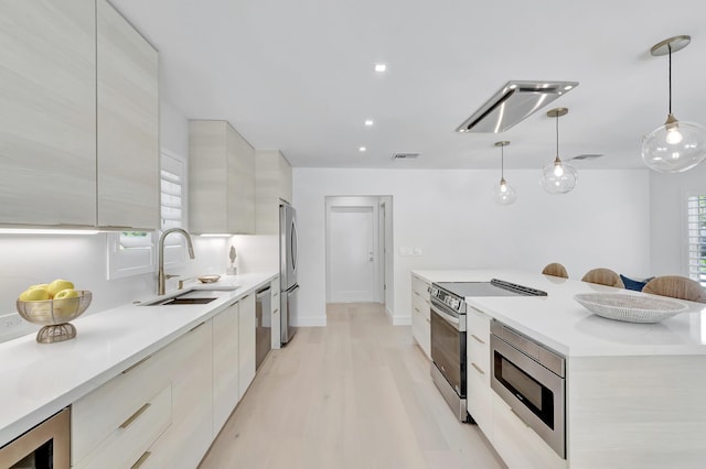 530 NW 14th St, Delray Beach, FL 33444 - kitchen with modern cabinets, appliances with stainless steel finishes, a sink, light countertops, and recessed lighting