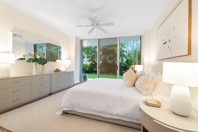 bedroom with multiple windows, ceiling fan, hardwood / wood-style floors, and access to outside