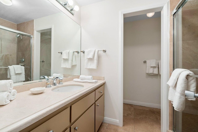 bathroom with tile patterned floors, walk in shower, and vanity