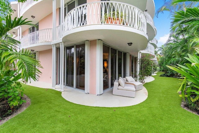 exterior space featuring a balcony and a yard