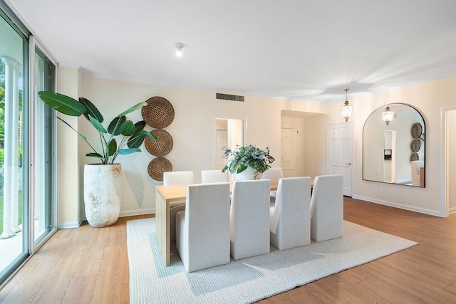 dining space featuring plenty of natural light and light hardwood / wood-style flooring