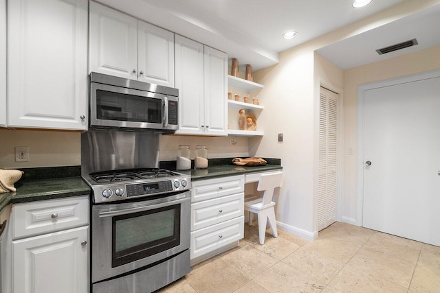 kitchen with white cabinets, light tile patterned floors, and stainless steel appliances