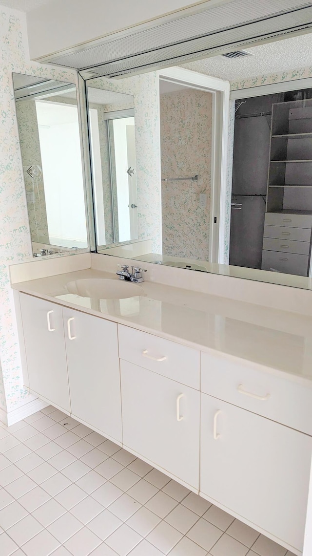 bathroom featuring tile patterned flooring and vanity