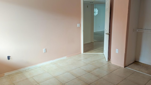 unfurnished bedroom with light tile patterned floors and a closet