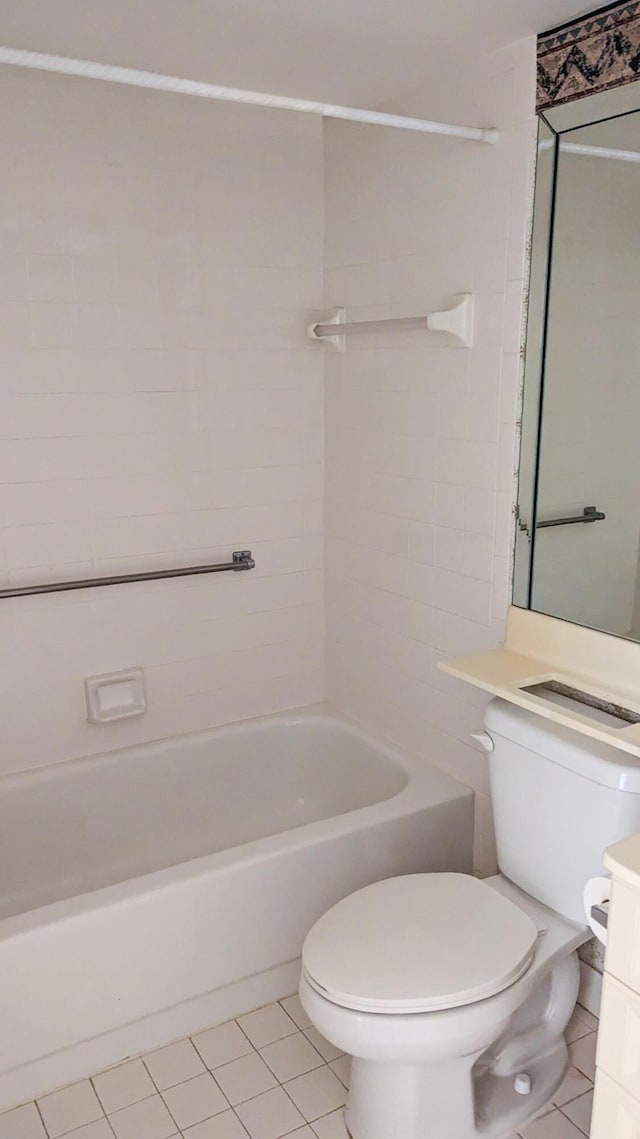 full bathroom with tile patterned flooring, vanity, tiled shower / bath combo, and toilet