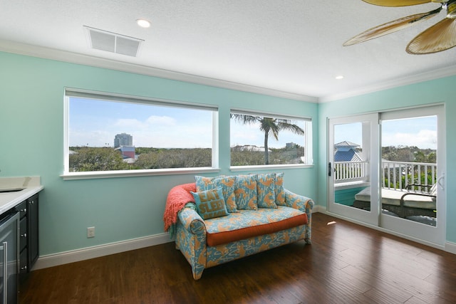 sitting room featuring ceiling fan, dark wood-type flooring, and plenty of natural light