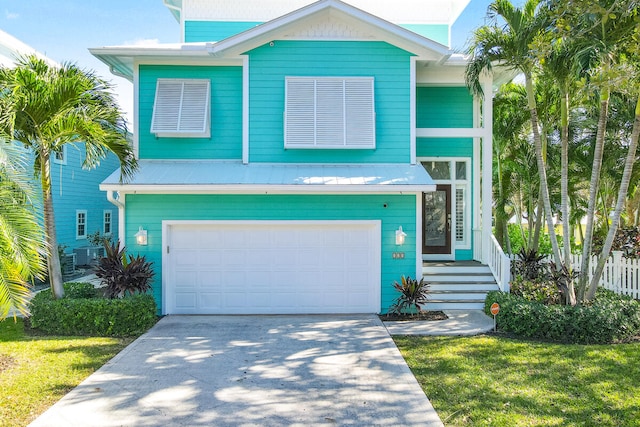 view of front of property featuring a garage and central AC unit