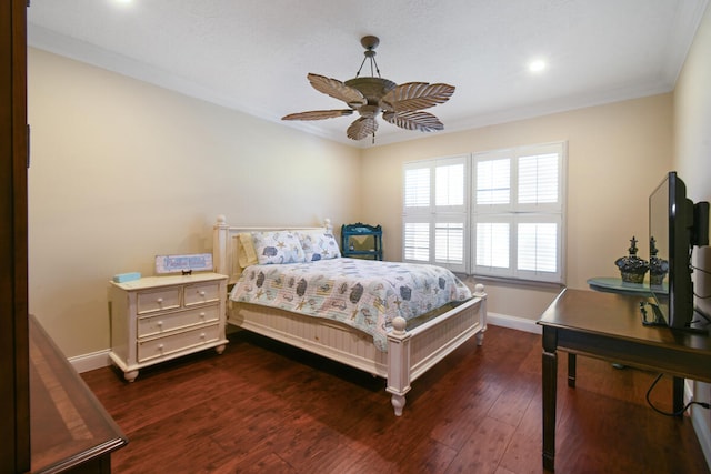 bedroom with crown molding, dark hardwood / wood-style floors, and ceiling fan