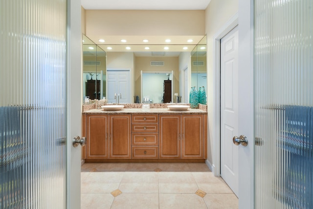 bathroom featuring tile patterned flooring and dual bowl vanity