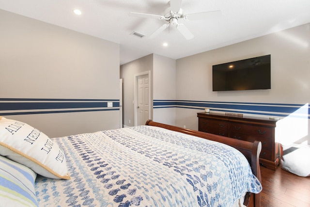 bedroom with dark hardwood / wood-style flooring and ceiling fan