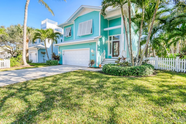 view of front of property featuring a garage and a front lawn