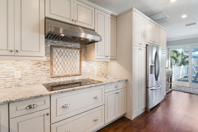 kitchen with decorative backsplash, dark wood-type flooring, light stone counters, and stainless steel fridge with ice dispenser