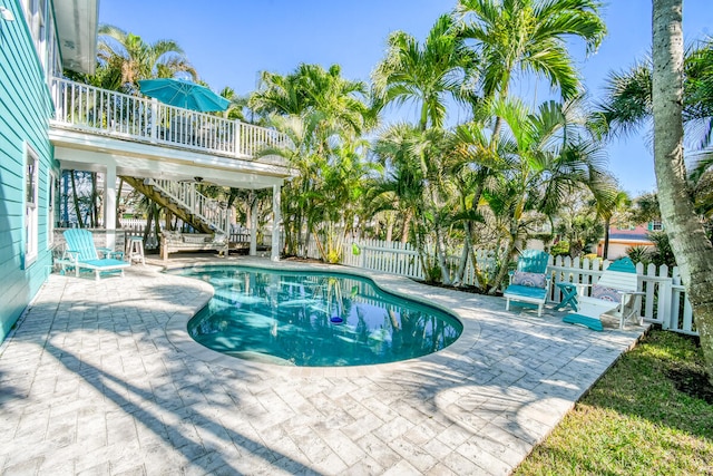 view of pool with a wooden deck and a patio