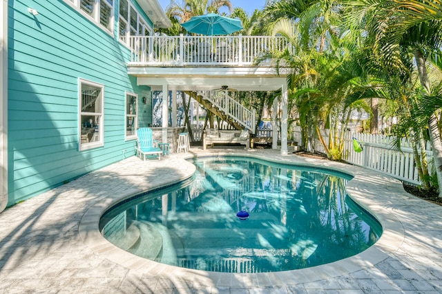 view of swimming pool with a patio and a deck