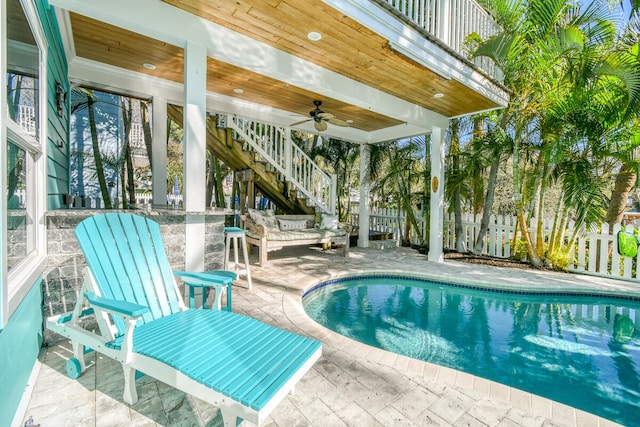 view of pool with ceiling fan and a patio area