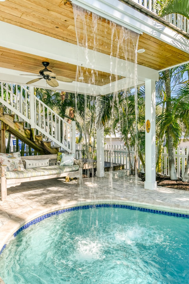 view of swimming pool with ceiling fan