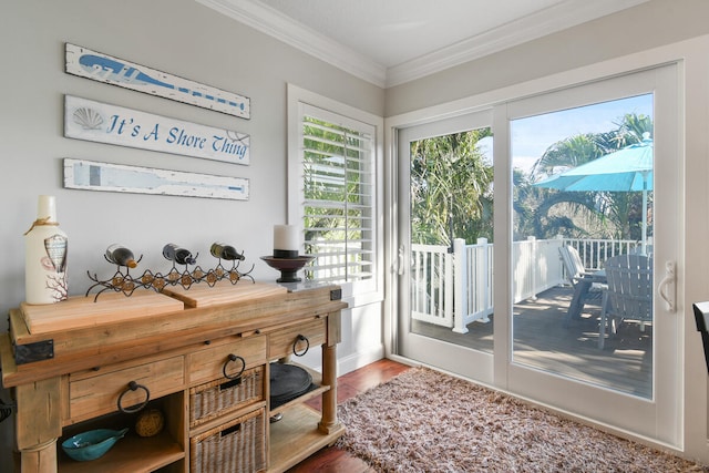 doorway to outside featuring hardwood / wood-style flooring and crown molding