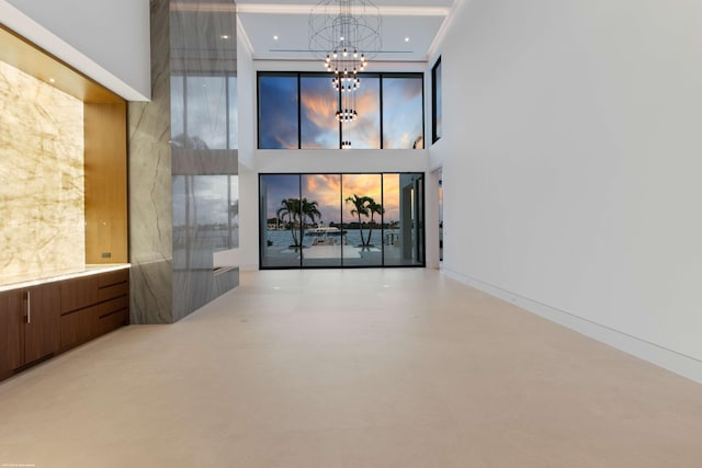 interior space with a towering ceiling and a chandelier